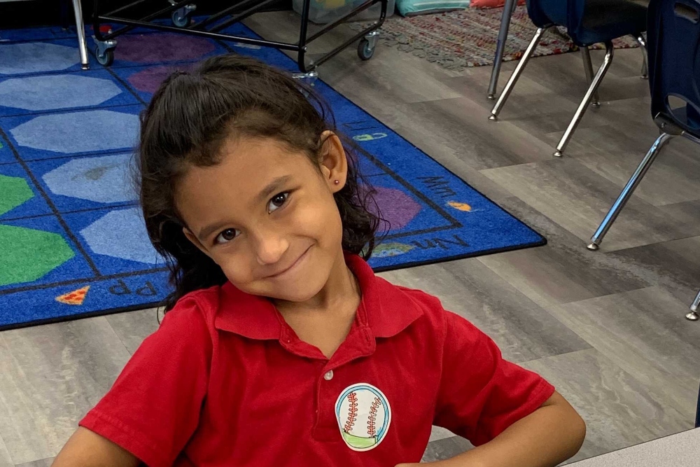 An Empower College Prep kindergarten student smiling.