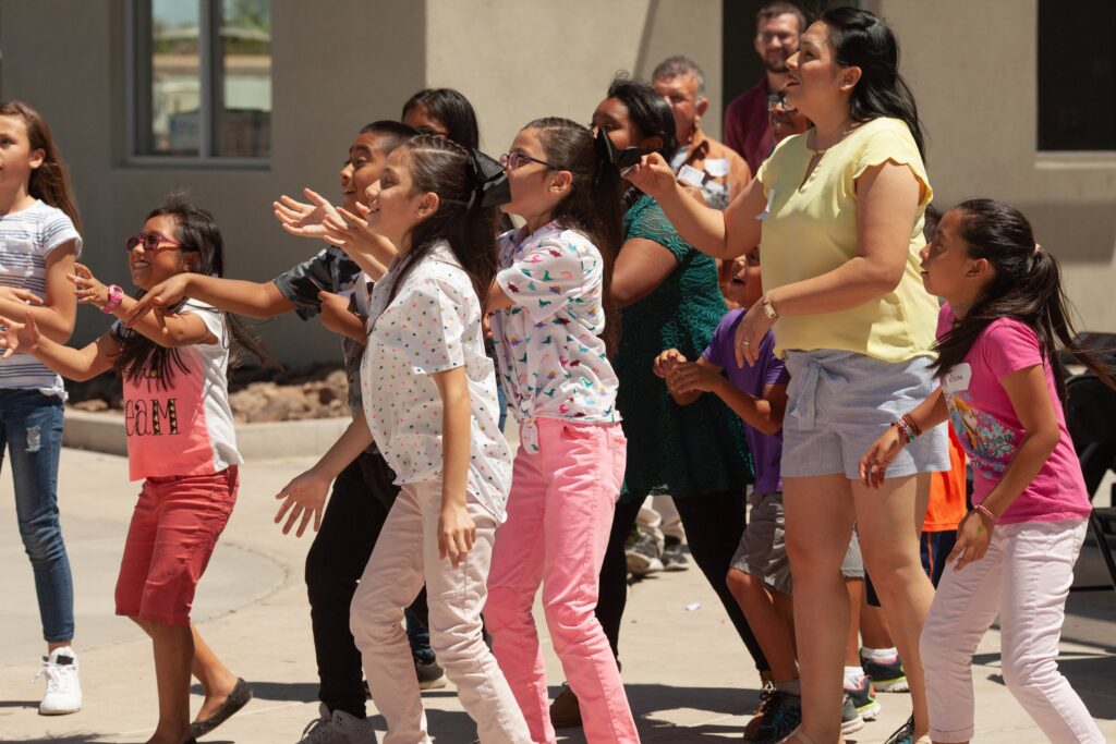 Empower College Prep Elementary-aged scholars gather together outside.