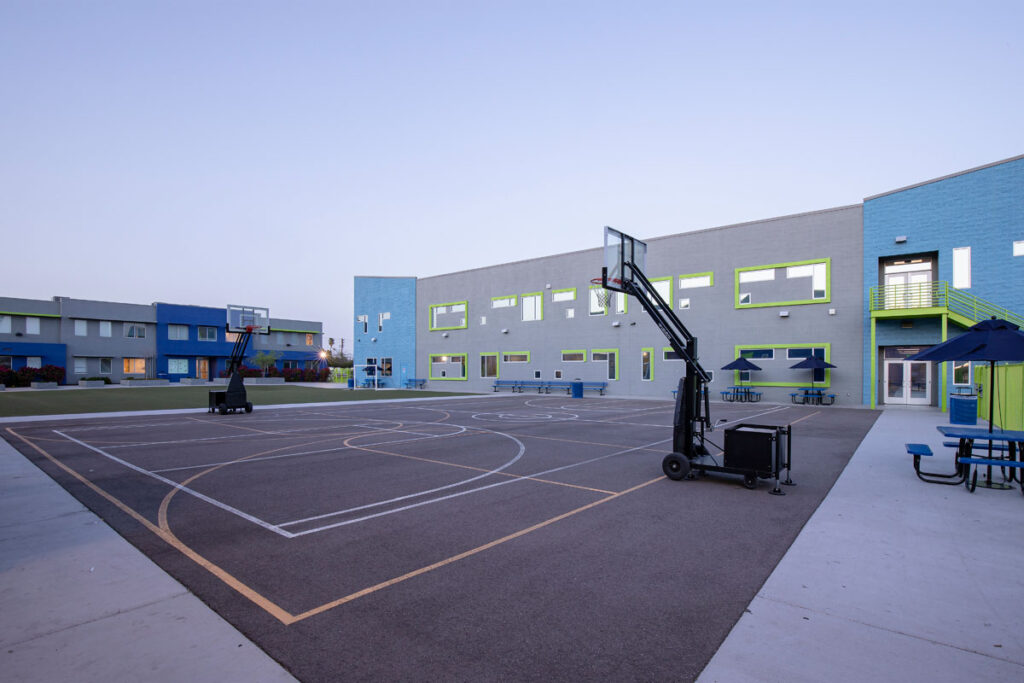 Empower College Prep’s exterior featuring an outdoor basketball court.