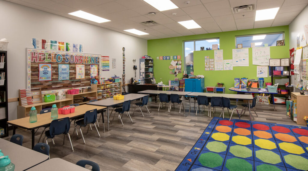 An Empower College Prep elementary classroom featuring brightly colored walls and a floor rug.