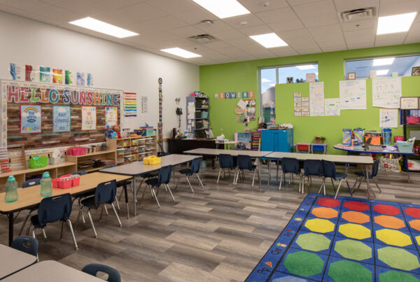 An Empower College Prep elementary classroom featuring brightly colored walls and a floor rug.