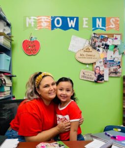 An Empower College Prep teacher hugs one of her students in their classroom. 