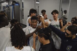 Empower College Prep boys [basketball] players fist-bump each other in the school’s locker room.