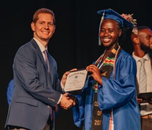 Empower College Prep Executive Director & High School Principal, Brian Holman congratulates an ECP senior as they receive their diploma.