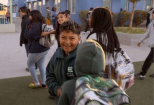 A group of Empower College Prep students from various grades arrive at school together in the morning.