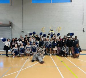 Several Empower College Prep students and other members of the community pose together in the school’s gym following a pep assembly.