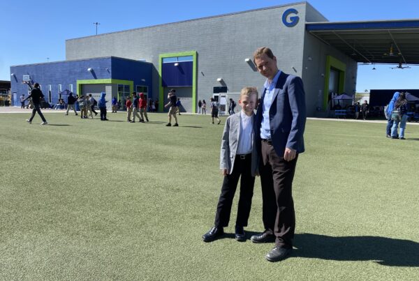 Empower College Prep Founder and Executive Director, Brian Holman stands with his son on the ECP campus.