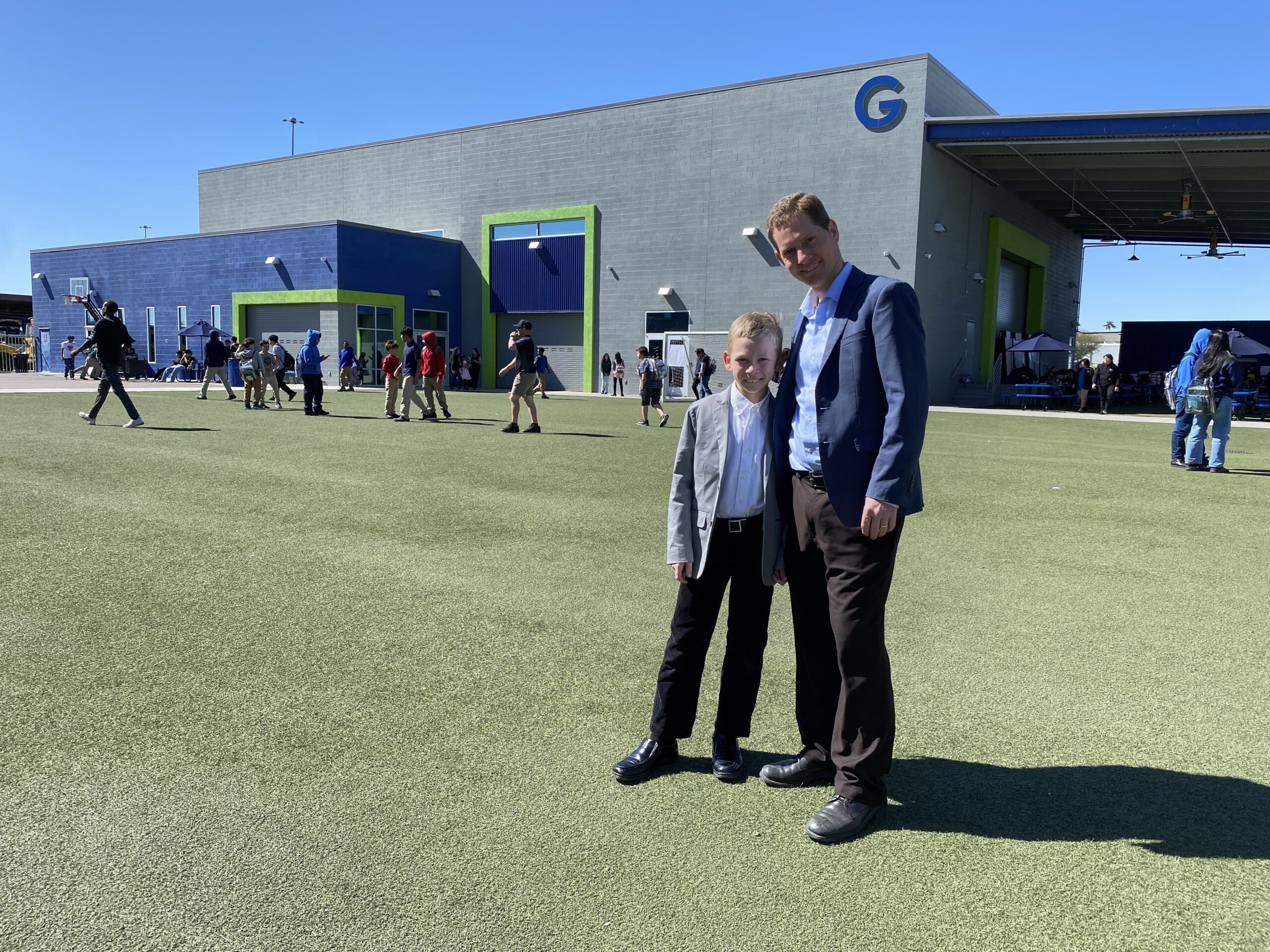 Empower College Prep Founder and Executive Director, Brian Holman stands with his son on the ECP campus.