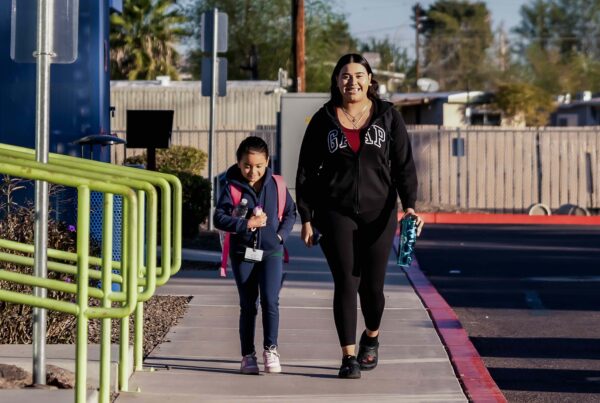 An Empower College Prep female elementary student walks with her mother on the school campus.
